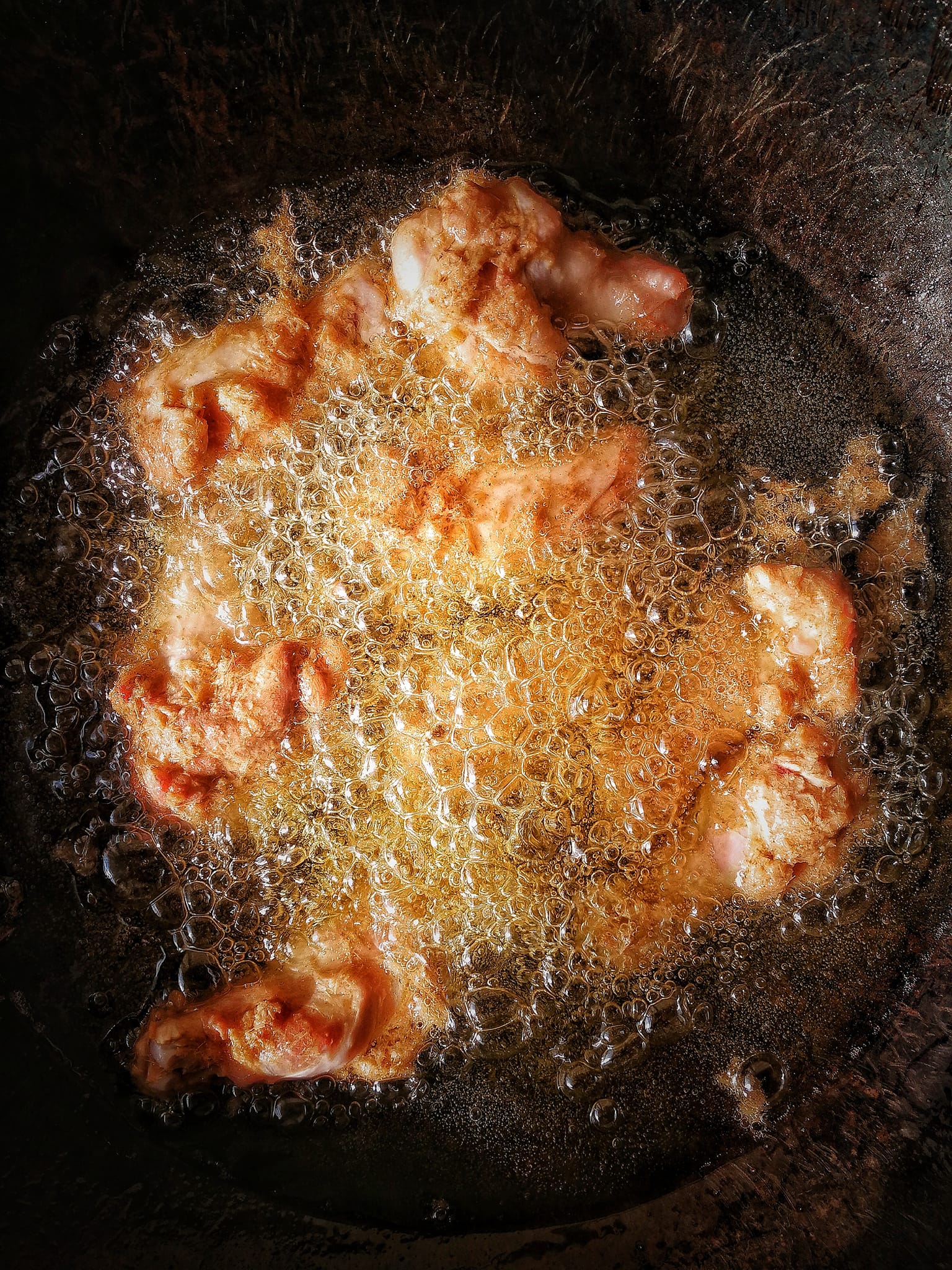 Fried chicken legs in the boiling oil